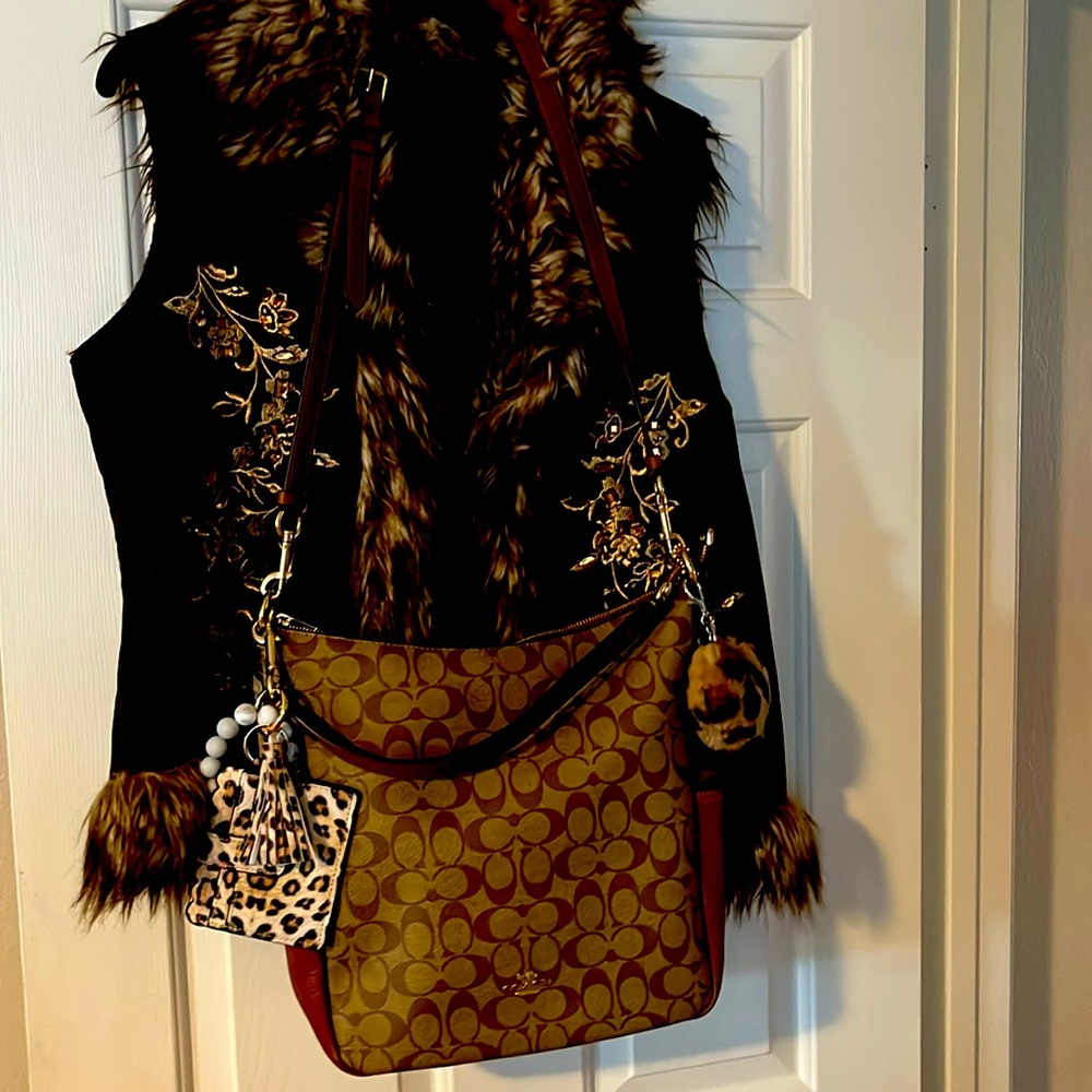 New with tags Coach tote with a jacket fur and jam stone work open front.